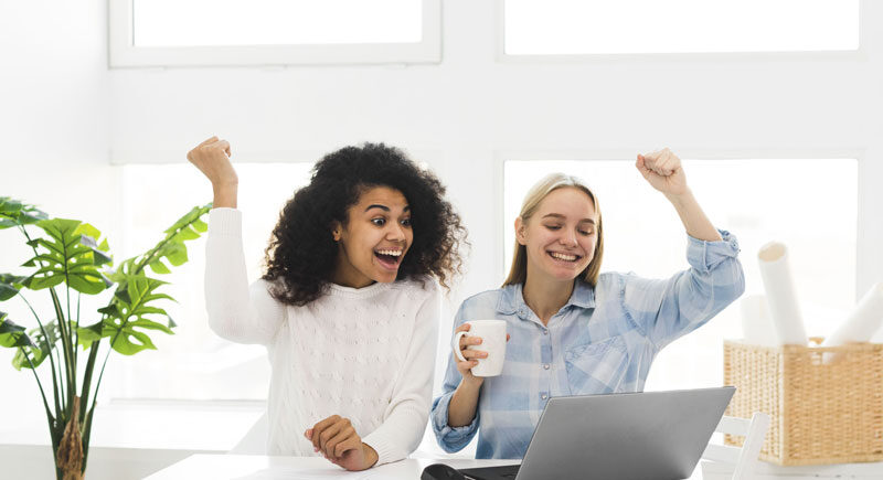 Two woman at work happy